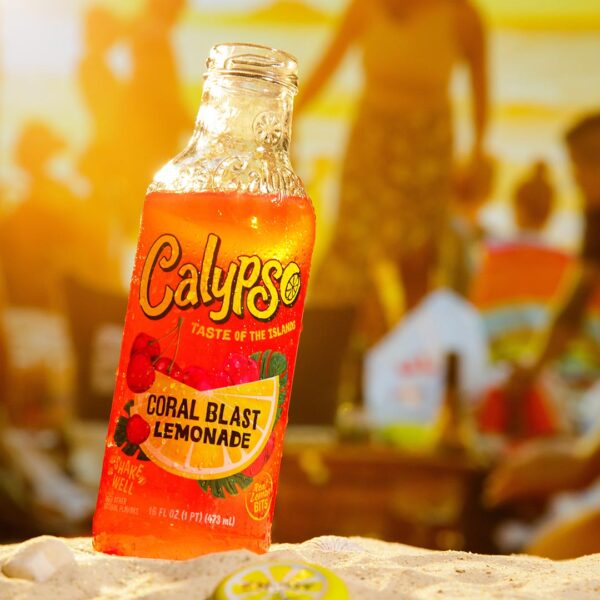 Calypso Coral Blast Lemonade in front of a group of people on the beach.