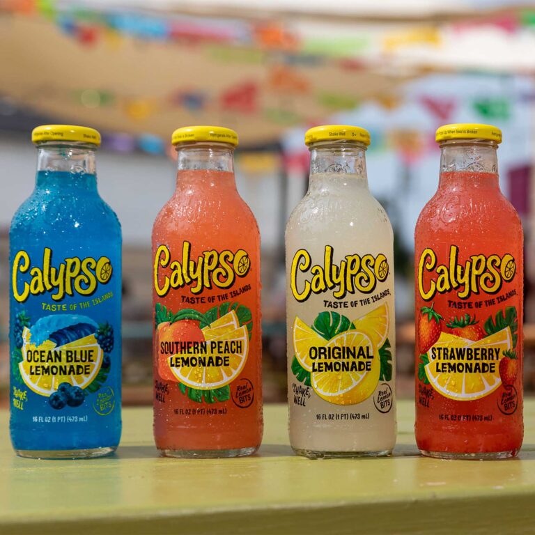 Four bottles of Calypso are lined up on a table.