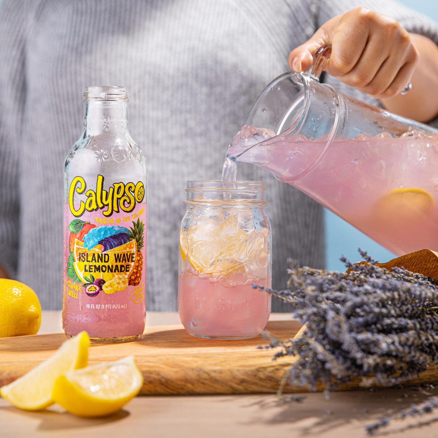 A person pouring Calypso Island Wave Lemonade into a glass.