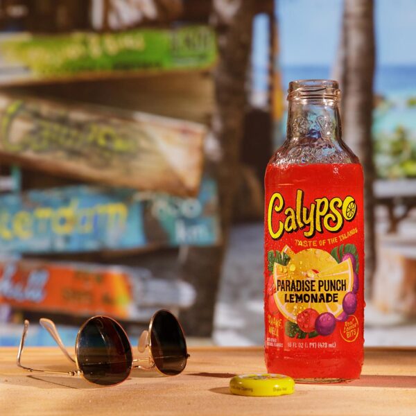 A bottle of Calypso Paradise Punch Lemonade sitting on a table next to sunglasses.
