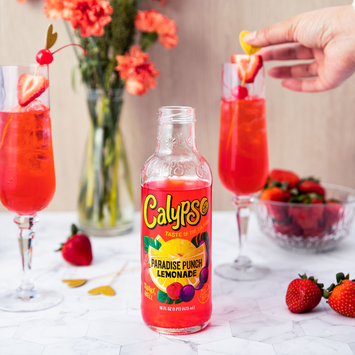 Calypso Paradise Punch Lemonade in a champaign flute with festive garnish.