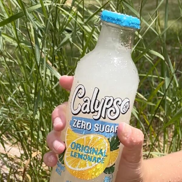 A person holding a bottle of Calypso Original Zero Sugar.